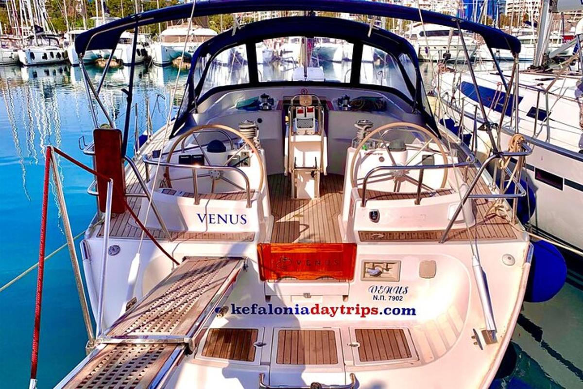 a white boat is docked in a harbor