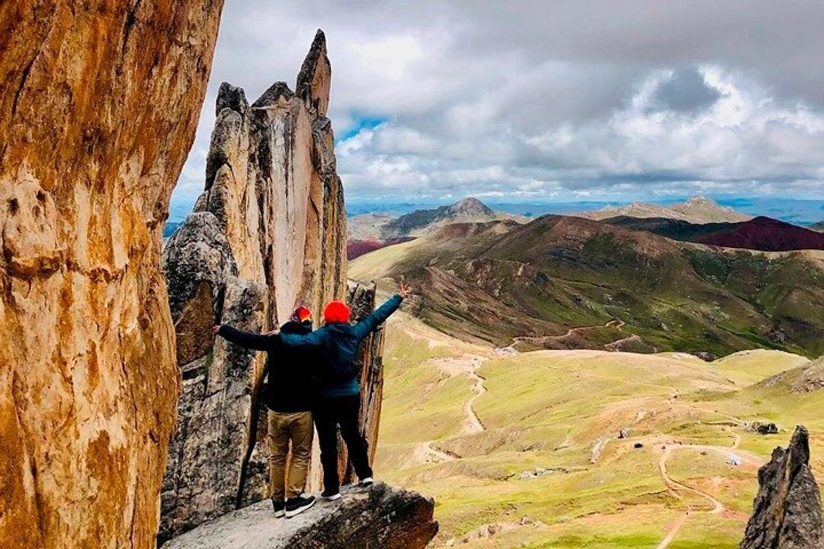 two people standing on top of a mountain