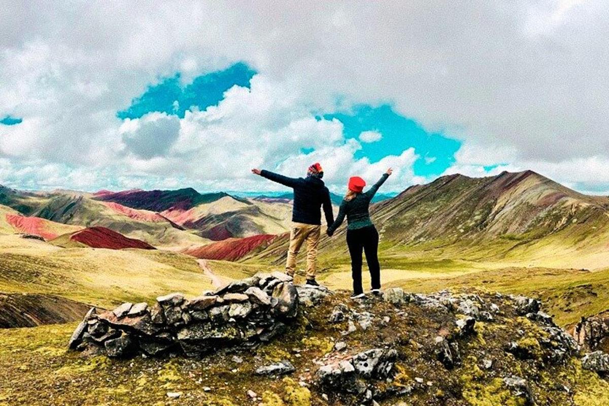 two people standing on top of a mountain