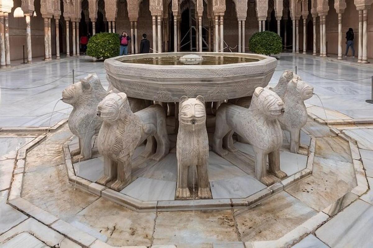 a statue of animals standing around a fountain in a building
