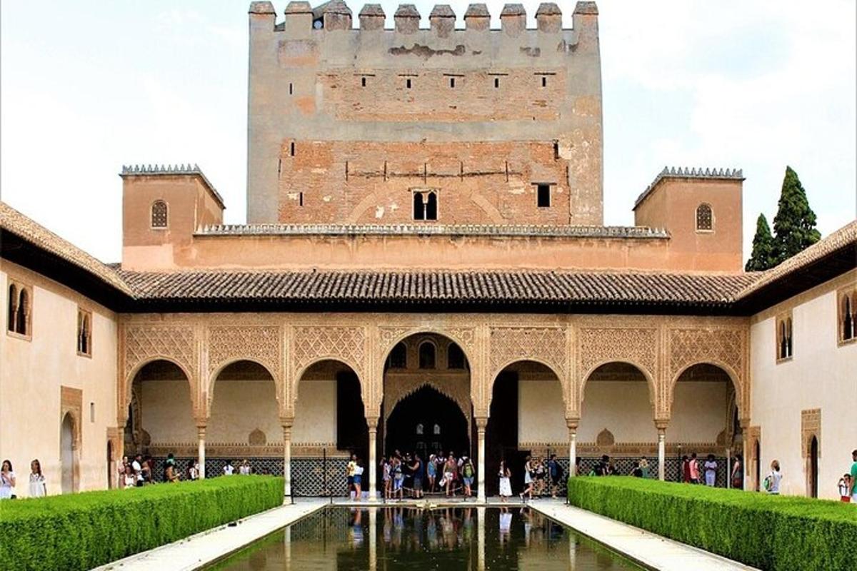 a building with a tower and a pool of water