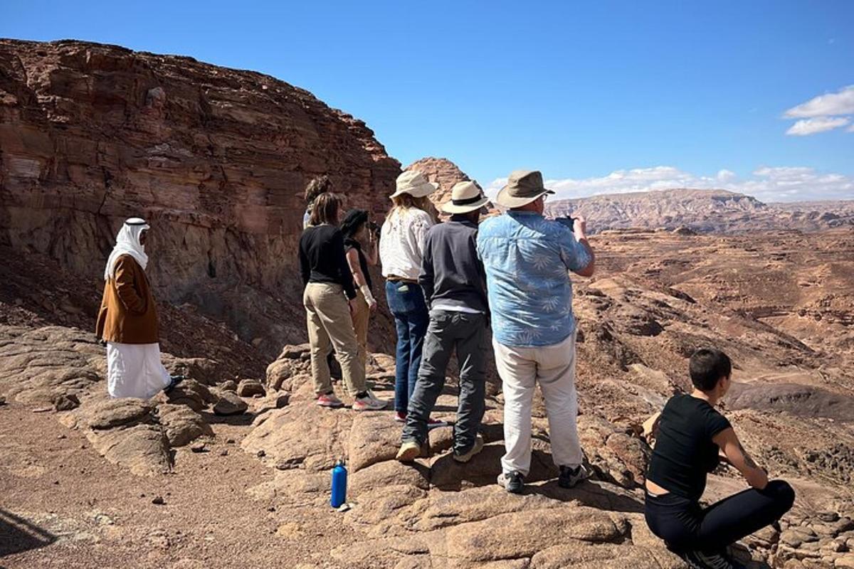 a group of people standing on the edge of a canyon