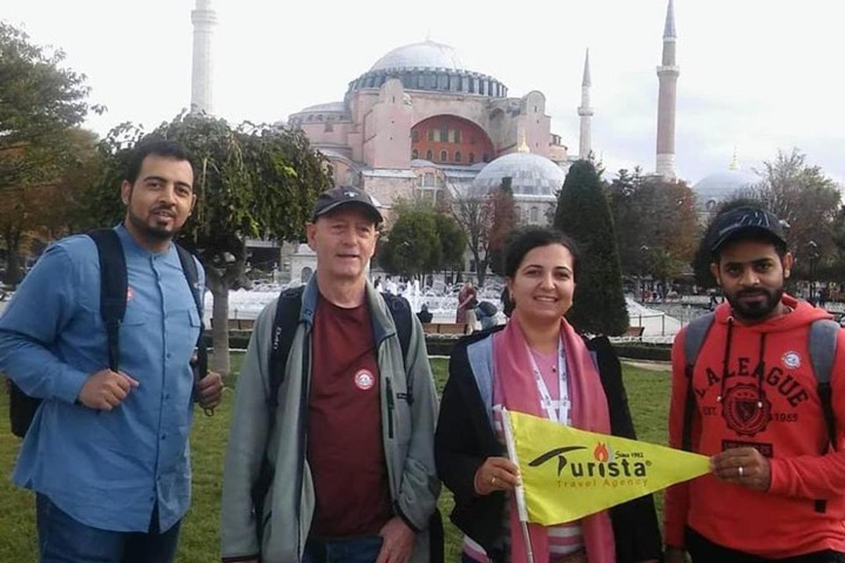 un gruppo di persone in piedi davanti a una moschea