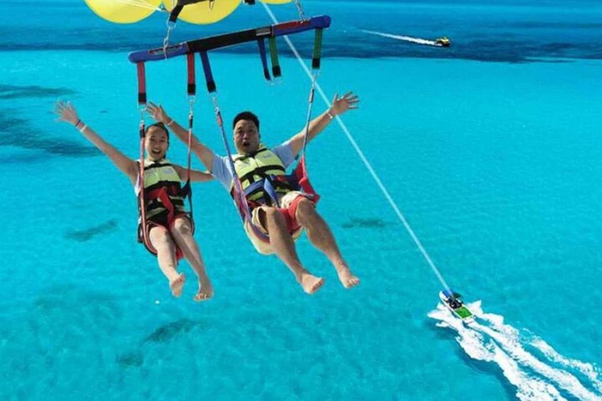 two people on a rope swing in the water