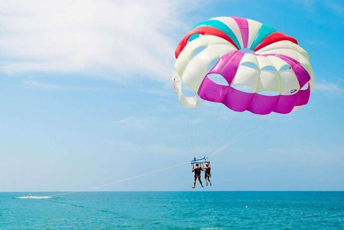 a person is para sailing in the ocean with a parachute