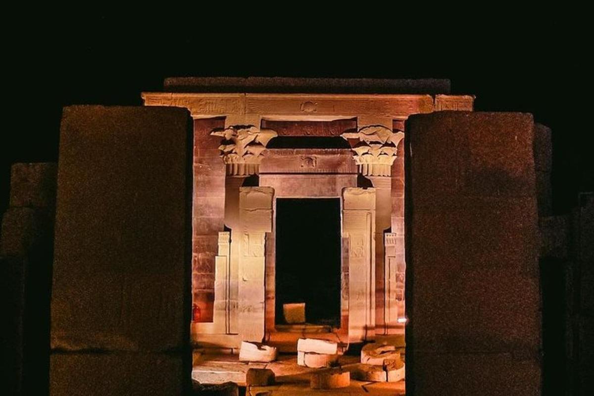 an ancient building with columns at night