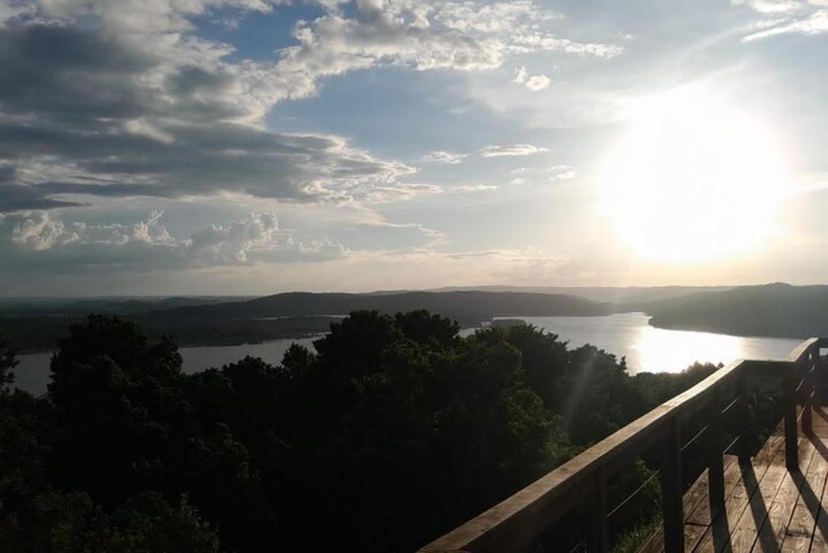 a view of a river with the sun in the sky