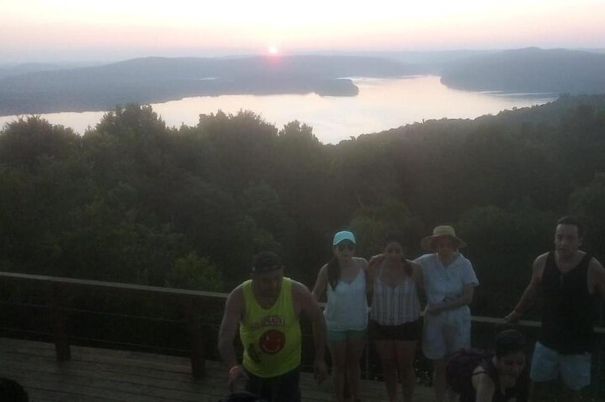 a group of people standing in front of a lake