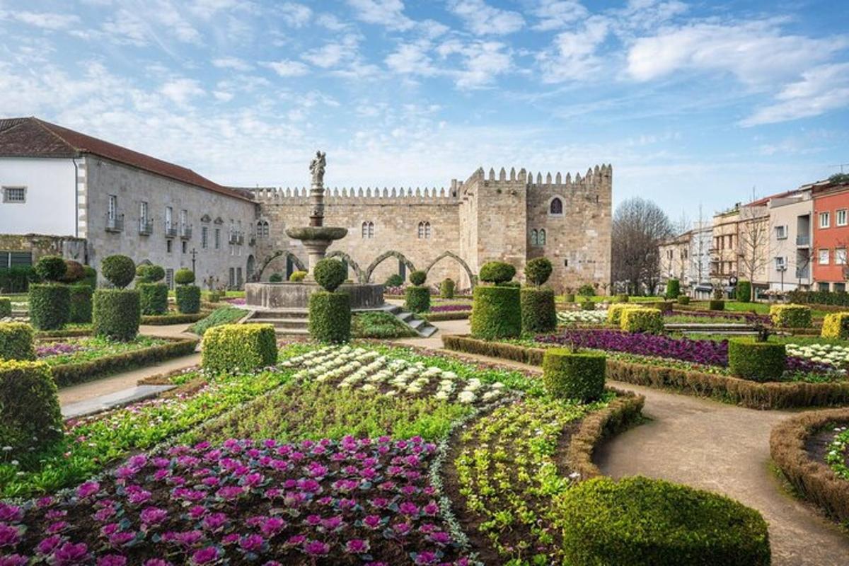 a garden with flowers in front of a castle