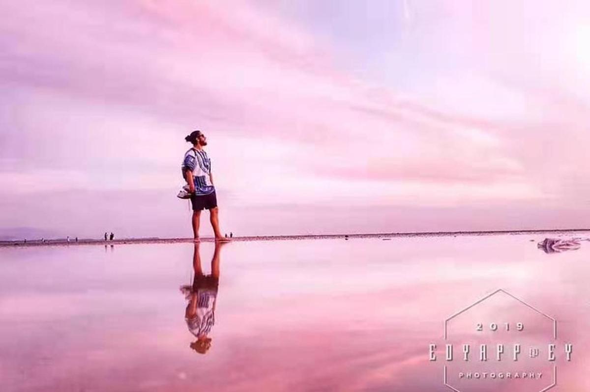 a person standing in the water on the beach