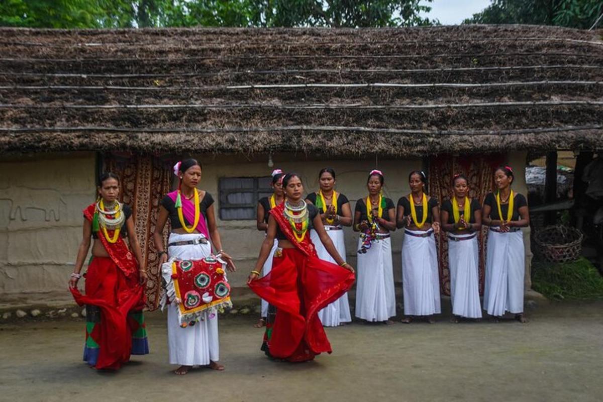 a group of women standing in front of a hut