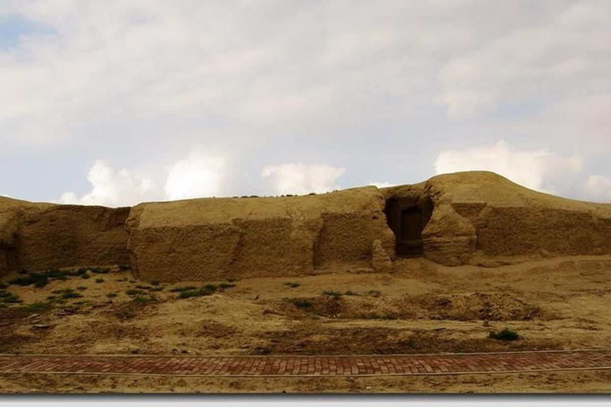 a rocky hill with a mountain in the background