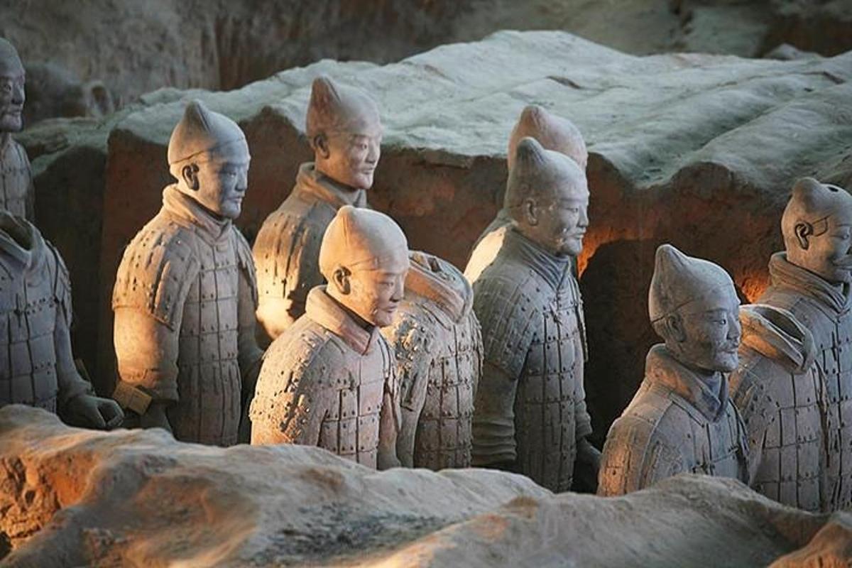 a group of statues of people standing in a group