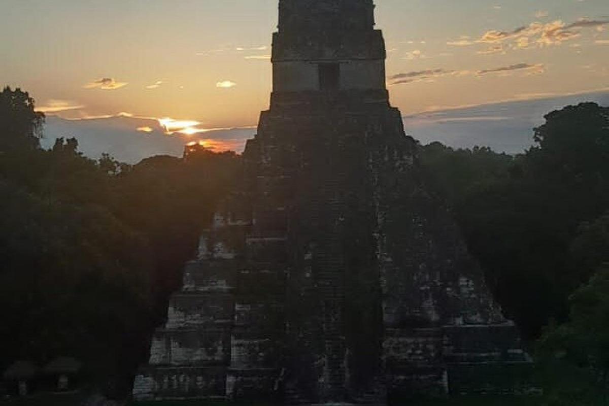 a large building with a sunset in the background