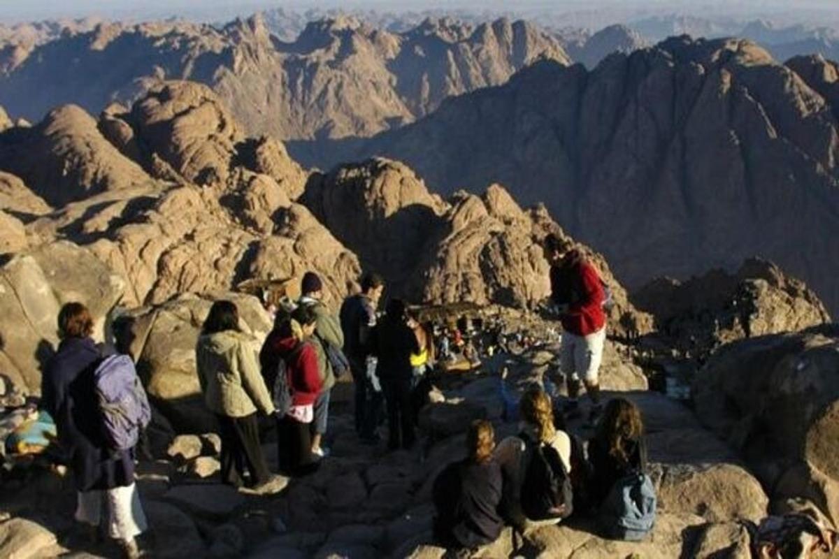 a group of people standing on the top of a mountain
