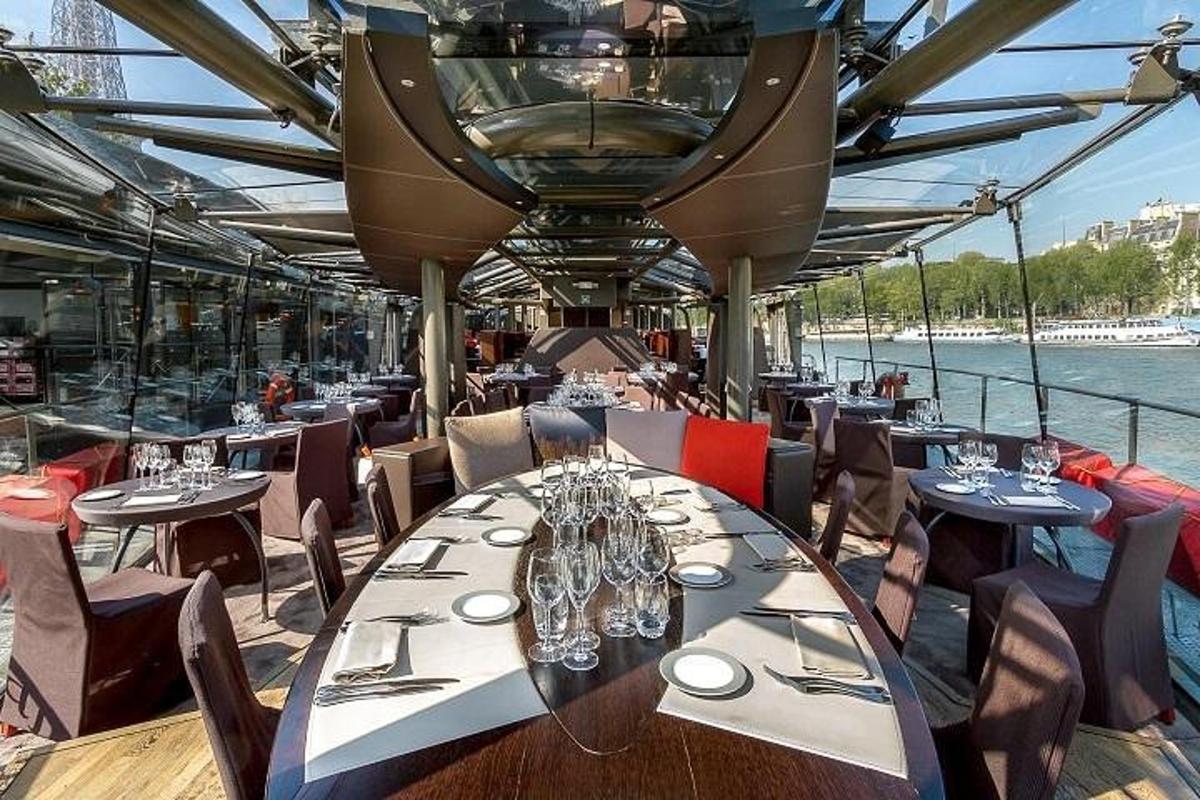 a dining room on a boat with tables and chairs