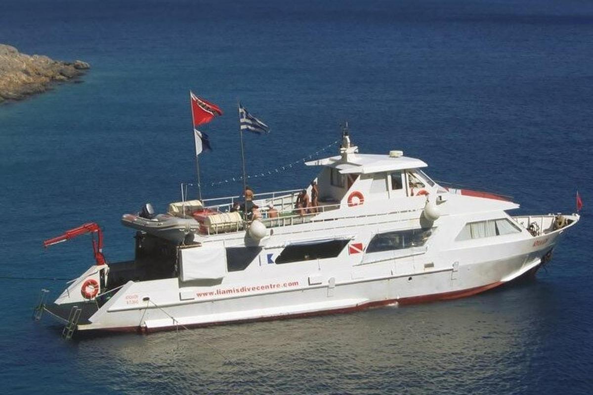 a white boat in the water with people on it
