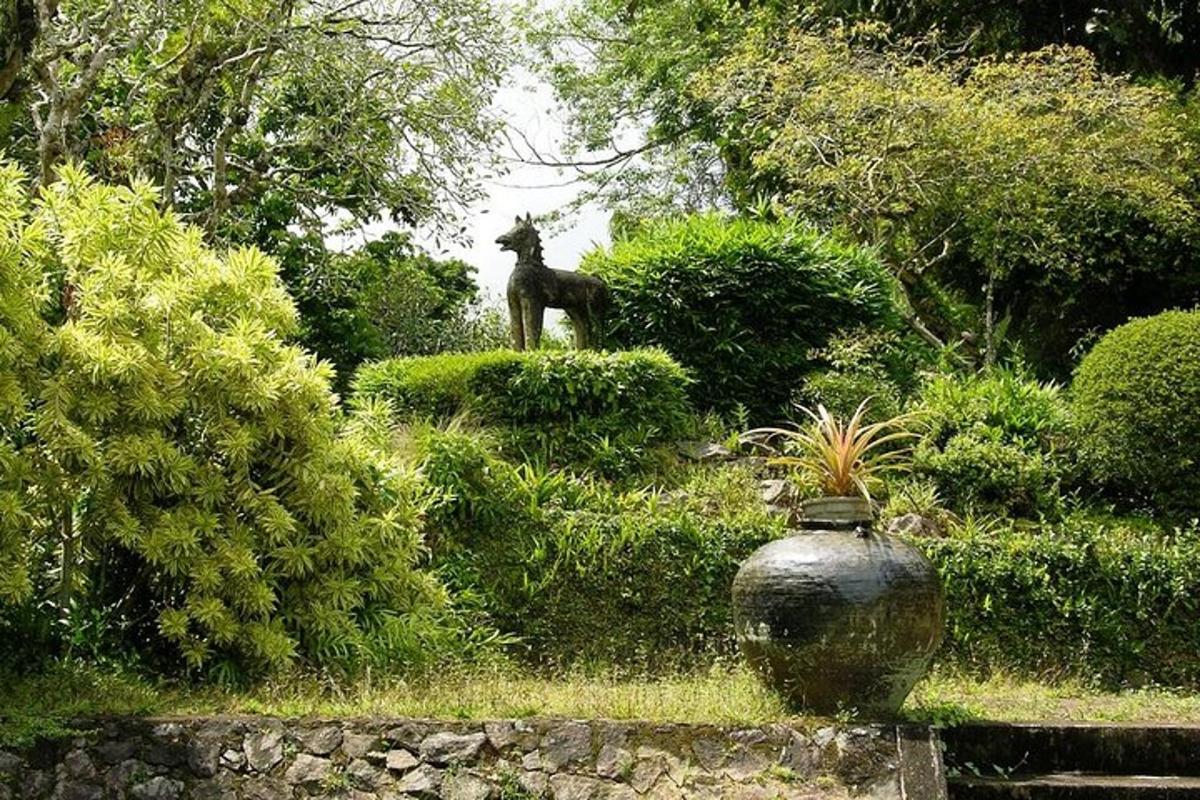 a statue of a horse standing on top of bushes