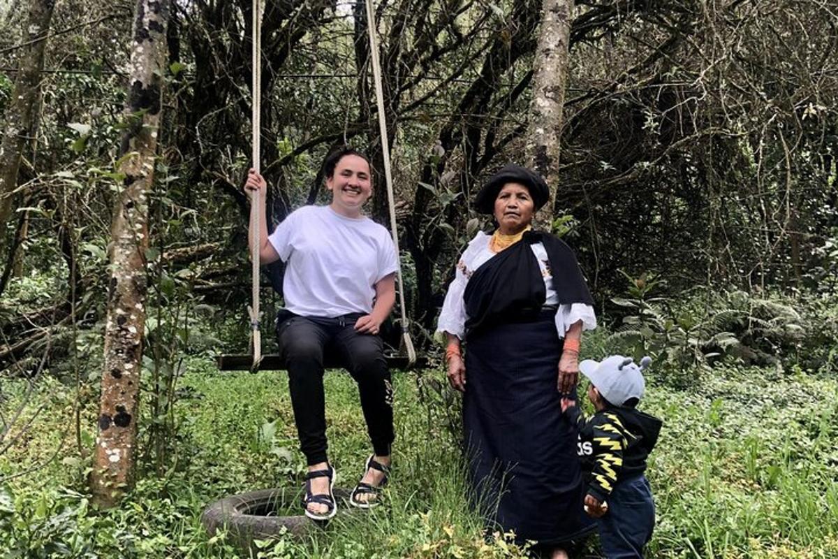 a man and a woman sitting on a swing with a child
