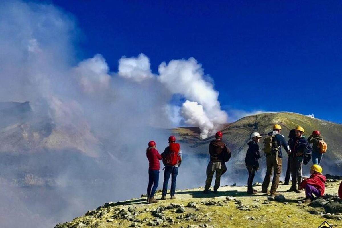 a group of people standing on top of a mountain