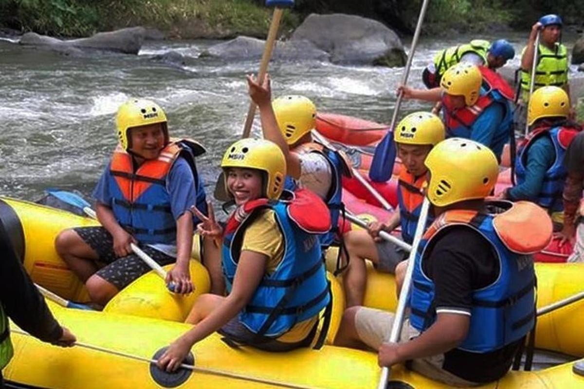 a group of people rafting down a river