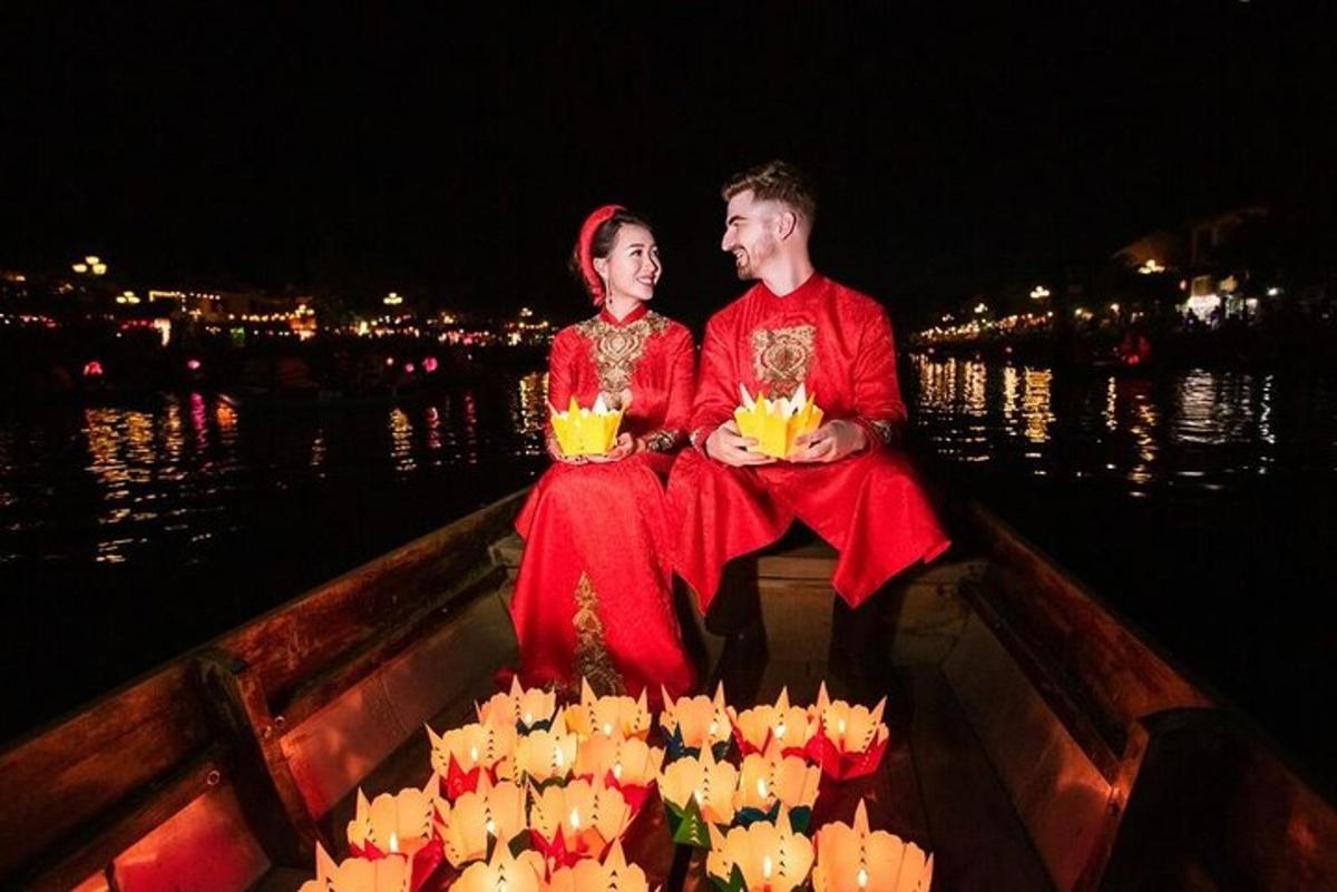 a man and a woman sitting on a boat with flowers