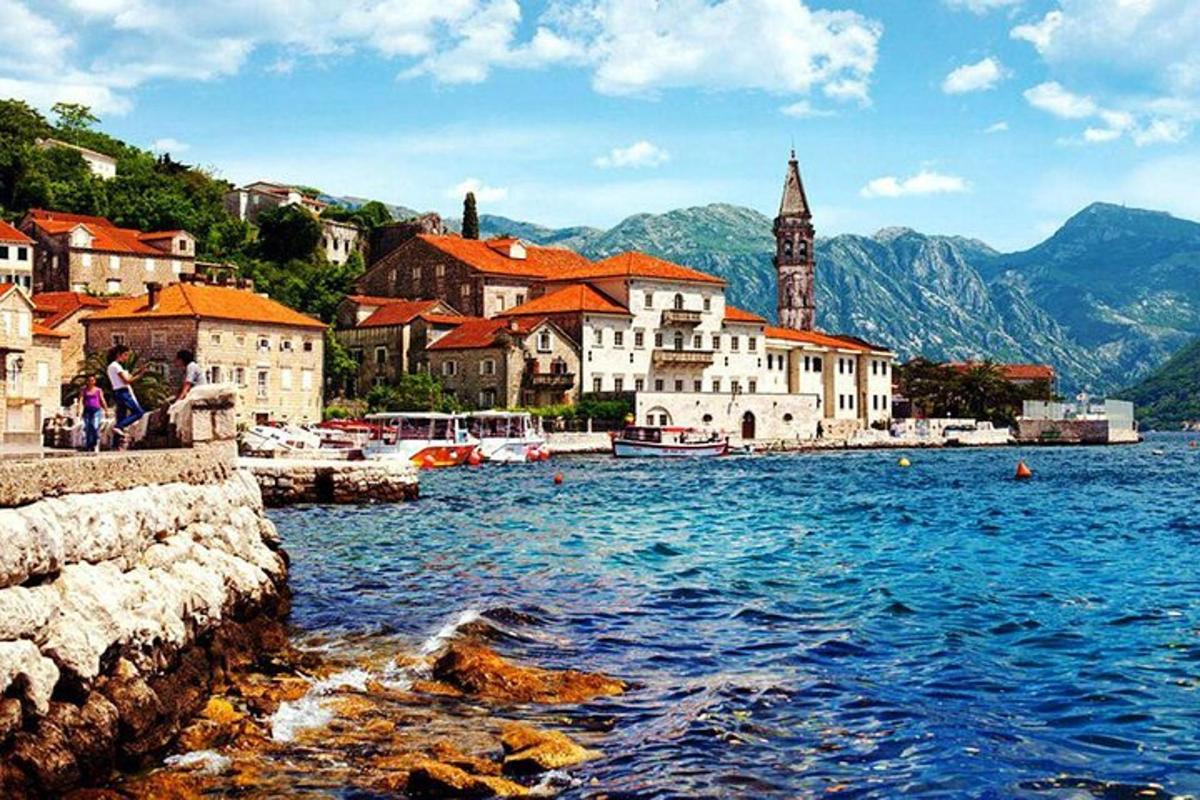a group of buildings on the shore of a body of water
