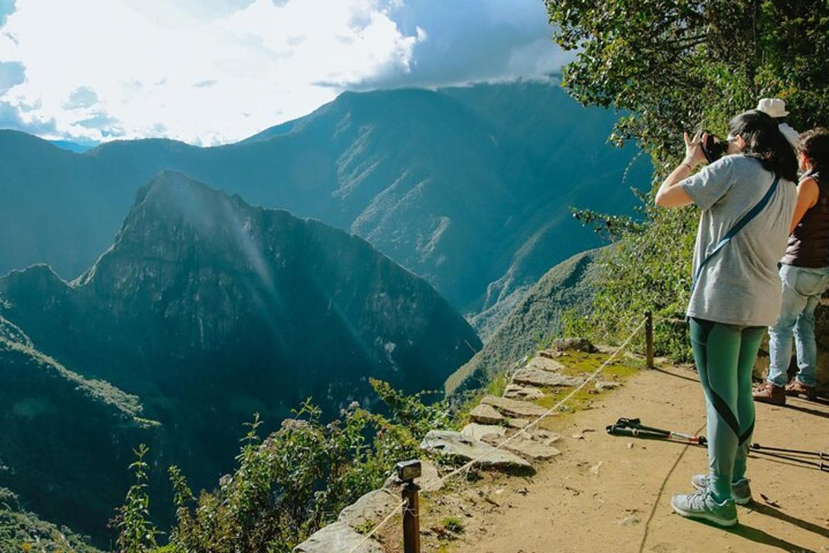 a woman taking a picture of the mountains
