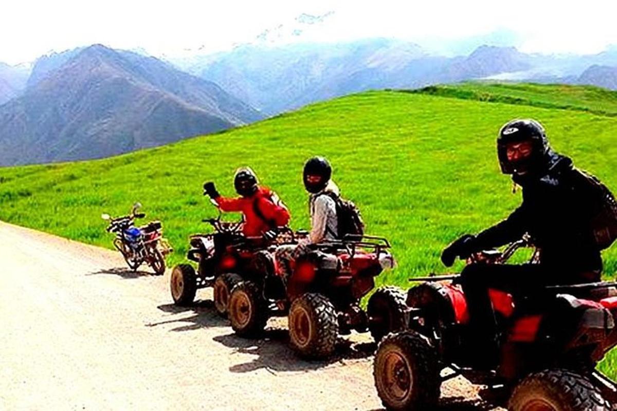 a group of people riding atvs down a mountain road