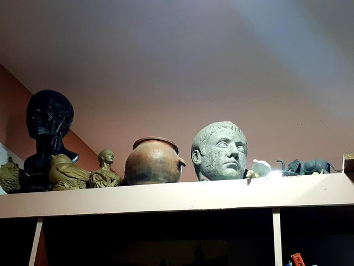 a group of busts on top of a shelf