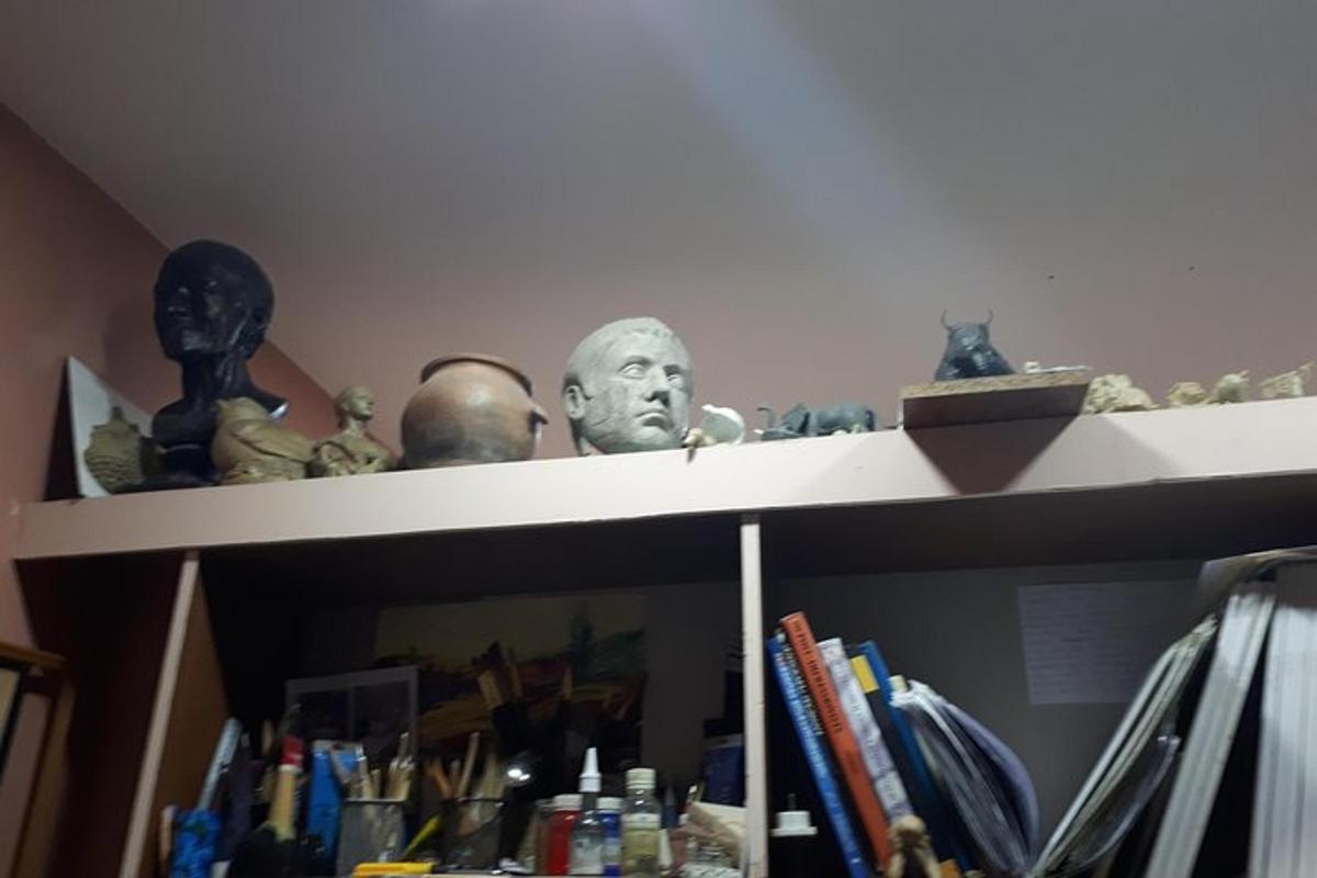 a shelf with a bust of a man on it