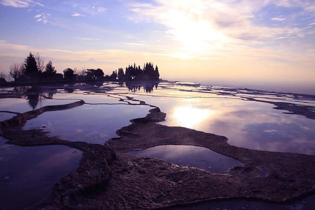 a reflection of the sun in a body of water