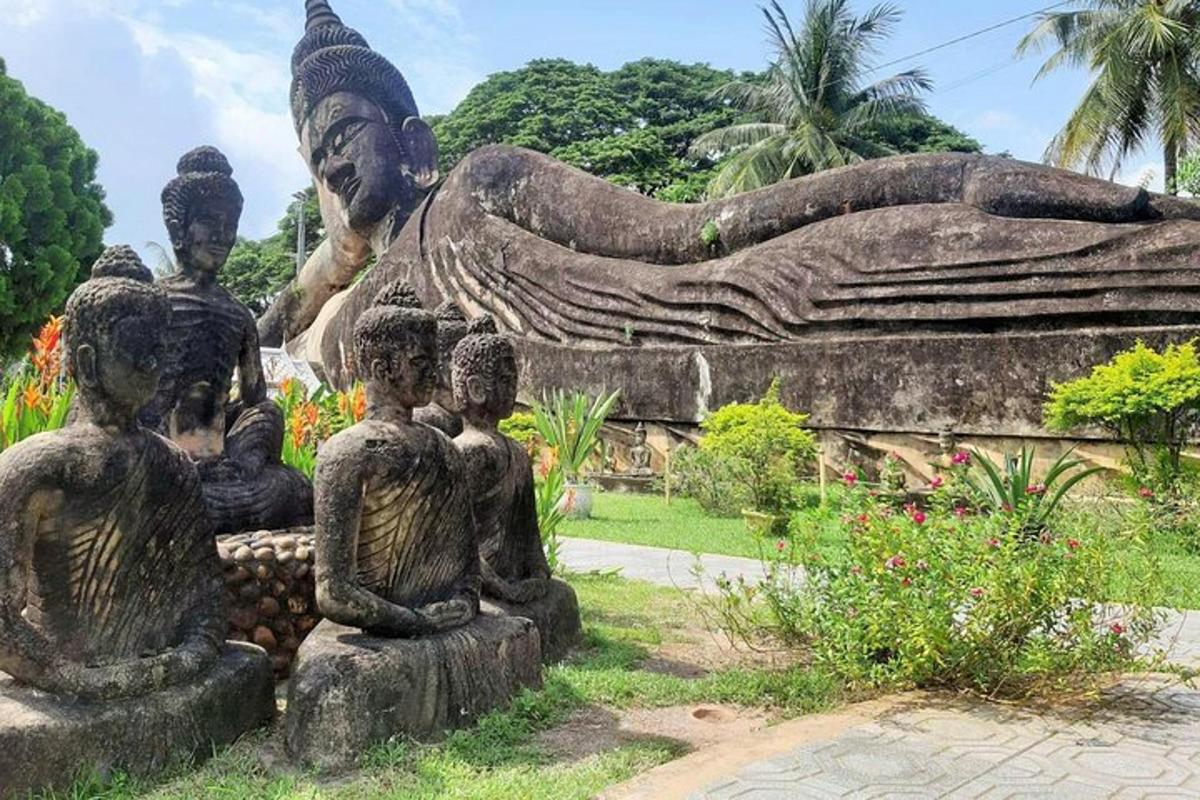 a statue of a woman and three children sitting on a bench