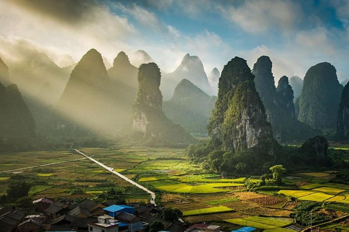 a view of a valley with mountains and a village