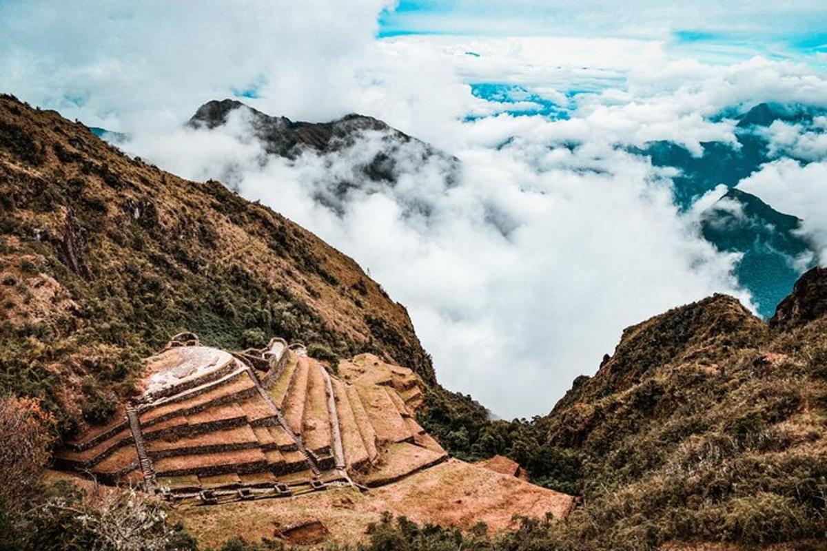 a view of a mountain with clouds in the background