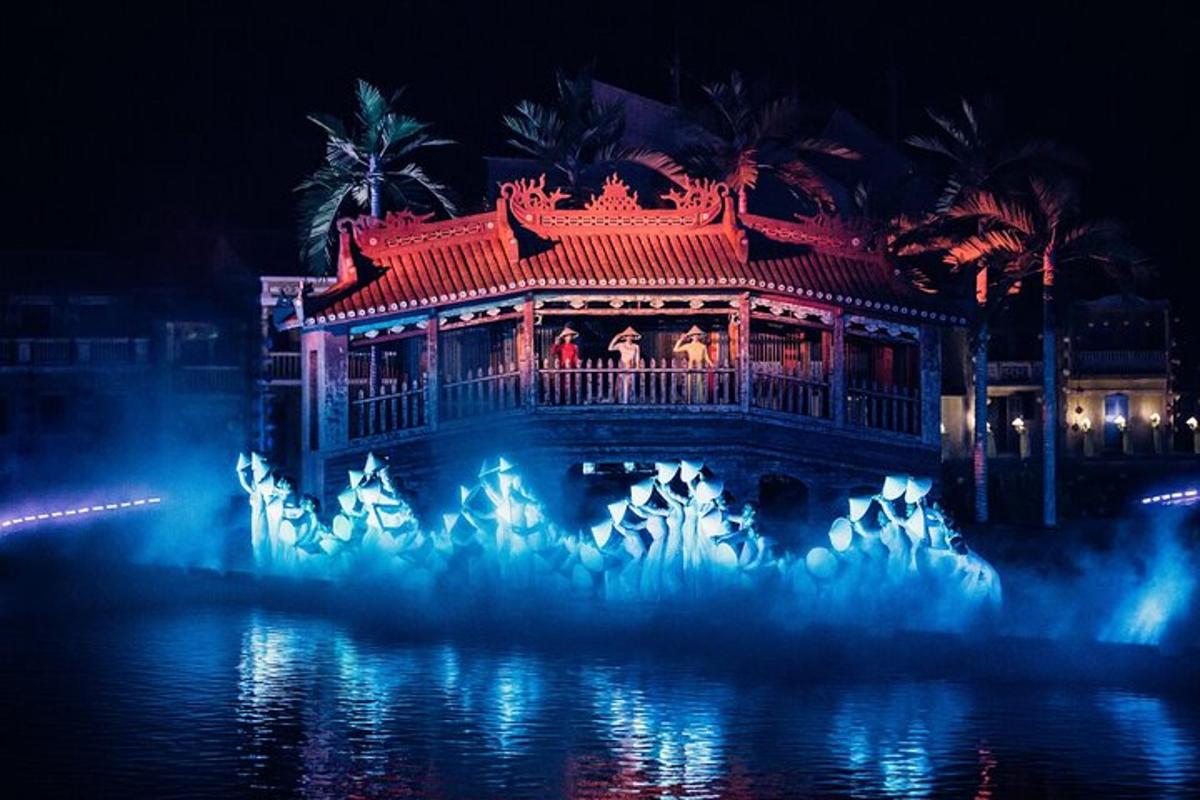 a building with a deck in the water at night