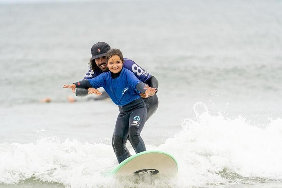 a woman and a child riding a wave on a surfboard