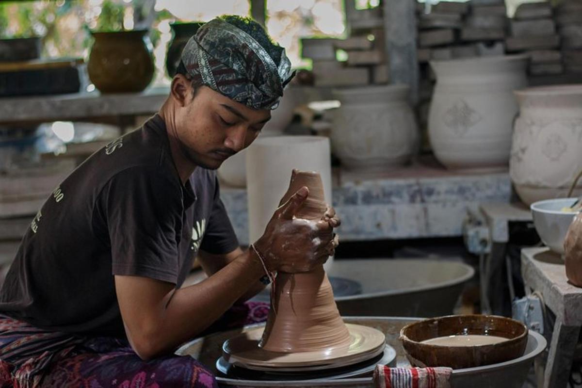 a man making a vase on a pottery wheel