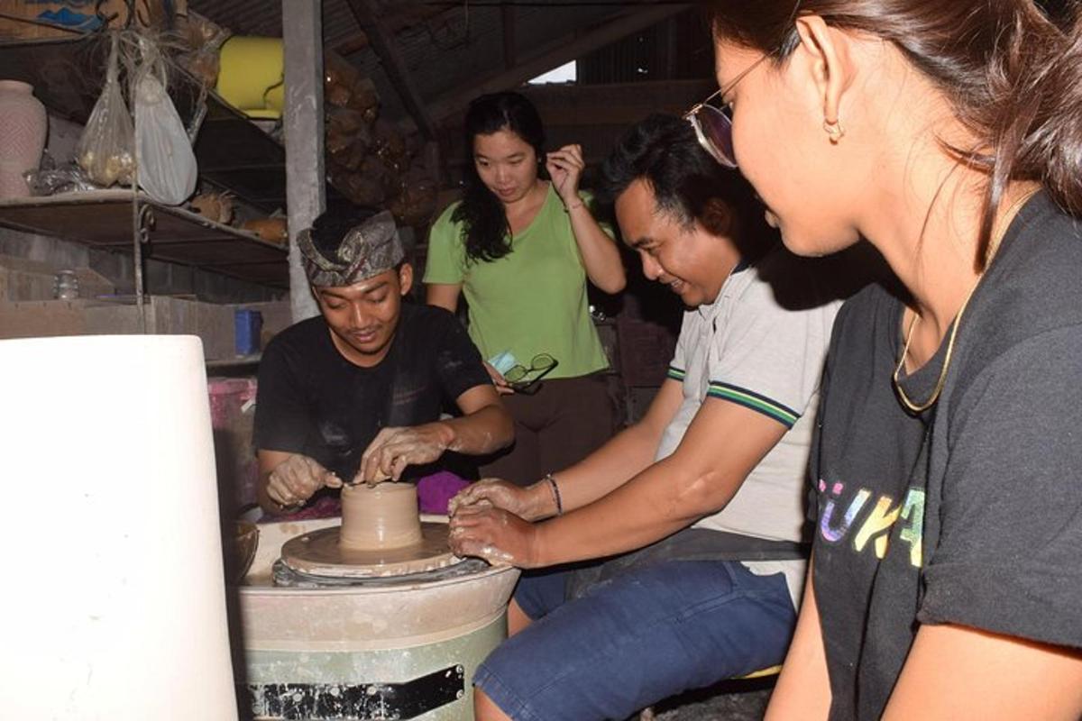 a group of people working on a pottery wheel