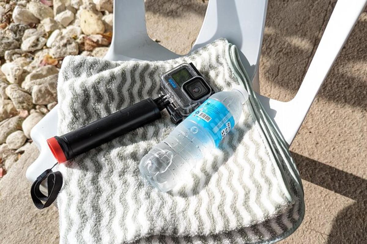 a camera and a bottle of water in a purse