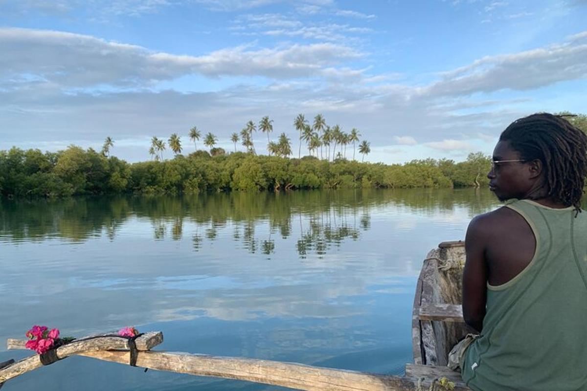 a man is sitting in a boat on a river