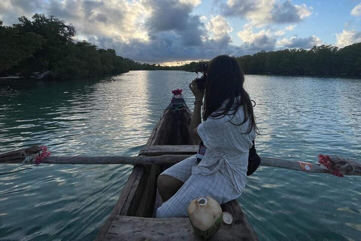 a woman sitting in a boat on the water