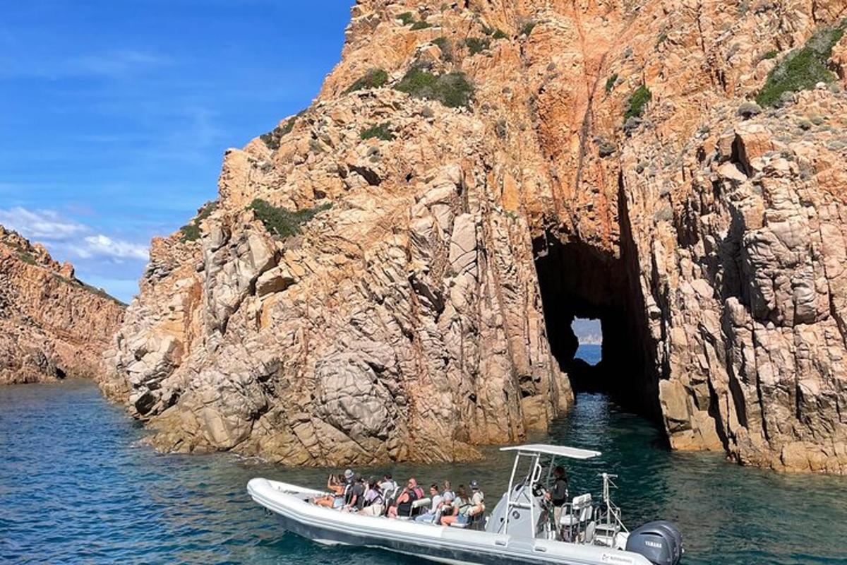 a group of people on a boat in front of a cave