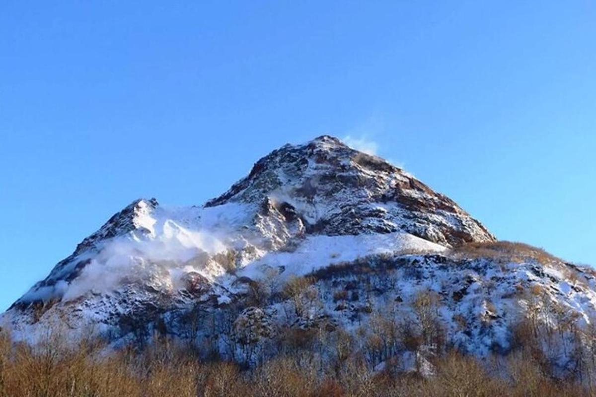 a mountain covered in snow on a clear day