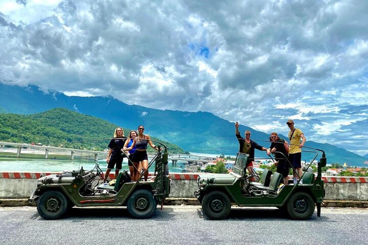 a group of people standing on top of jeeps