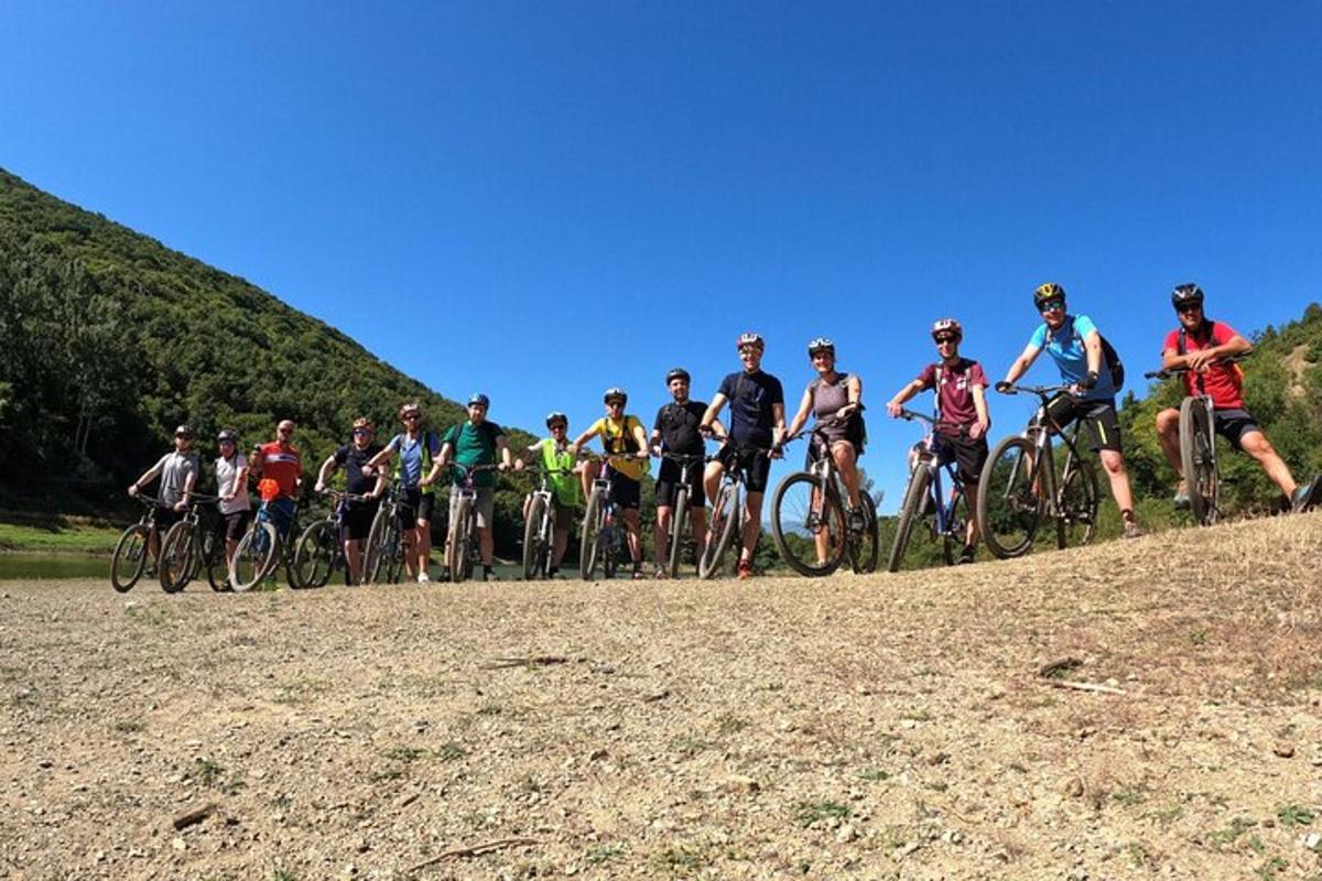 a group of people riding bikes on a hill