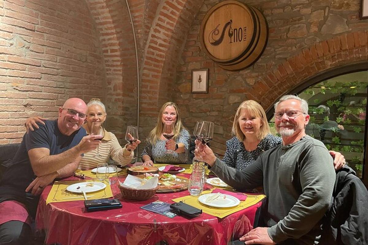 a group of people sitting around a table drinking wine