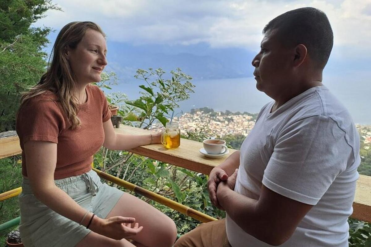 a man and a woman sitting at a table with a glass of beer