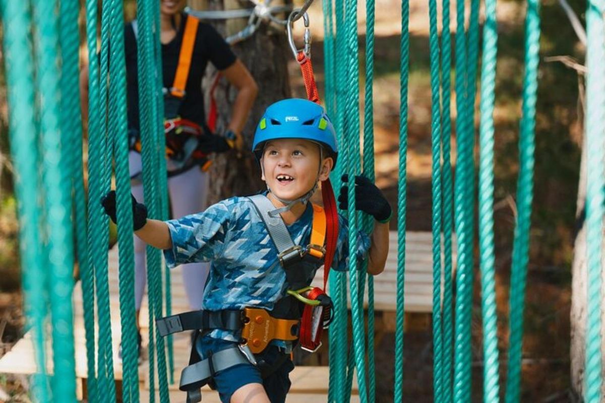 a young boy is climbing on a zip line