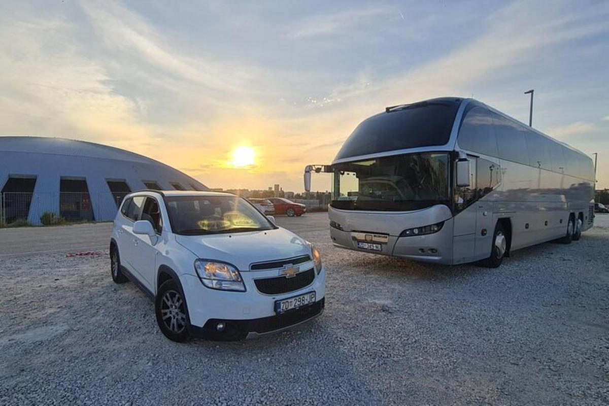 um ônibus e um carro estacionados ao lado de um ônibus
